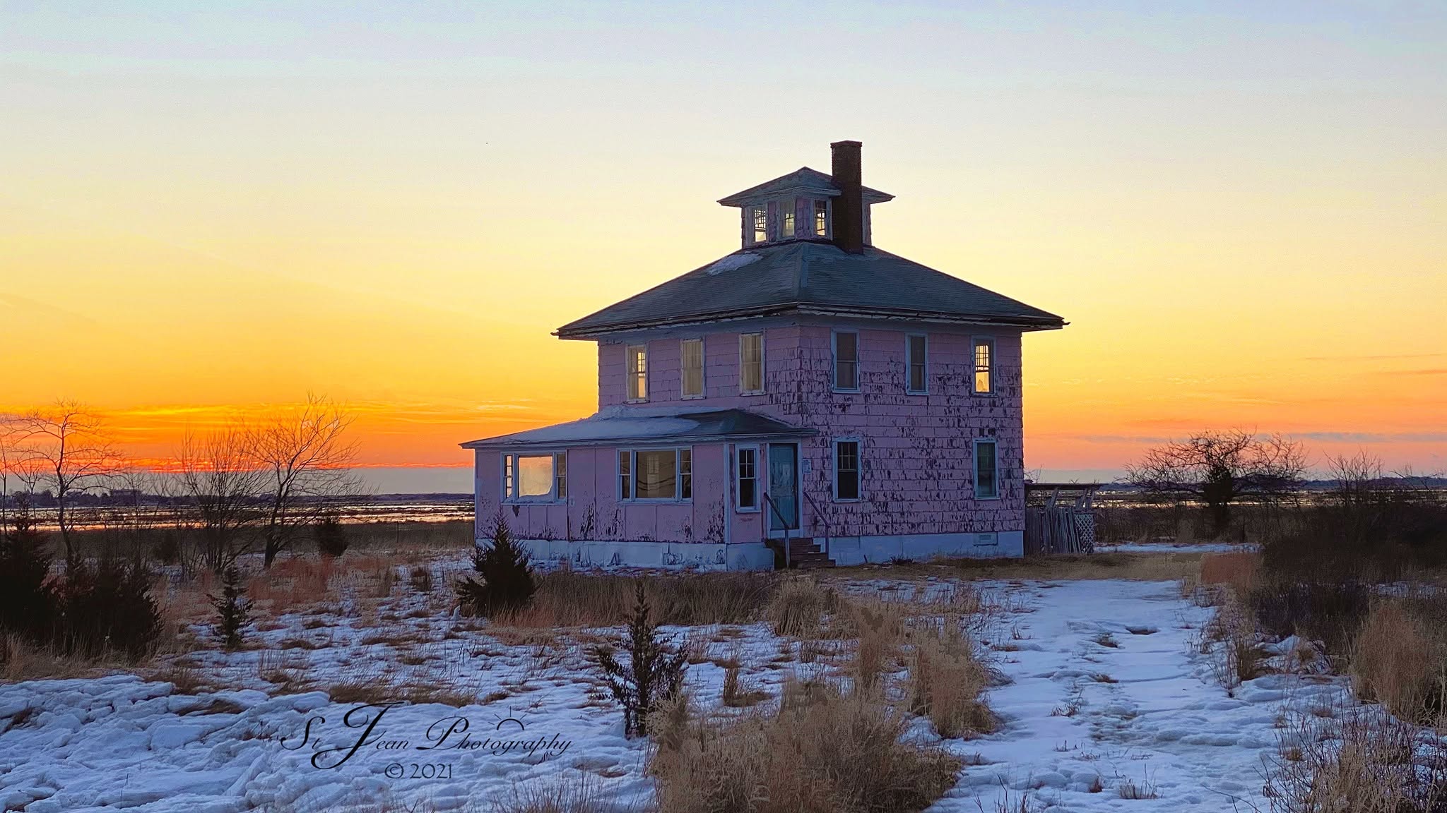 The Pink House at sunset in the snow beside the Great Marsh